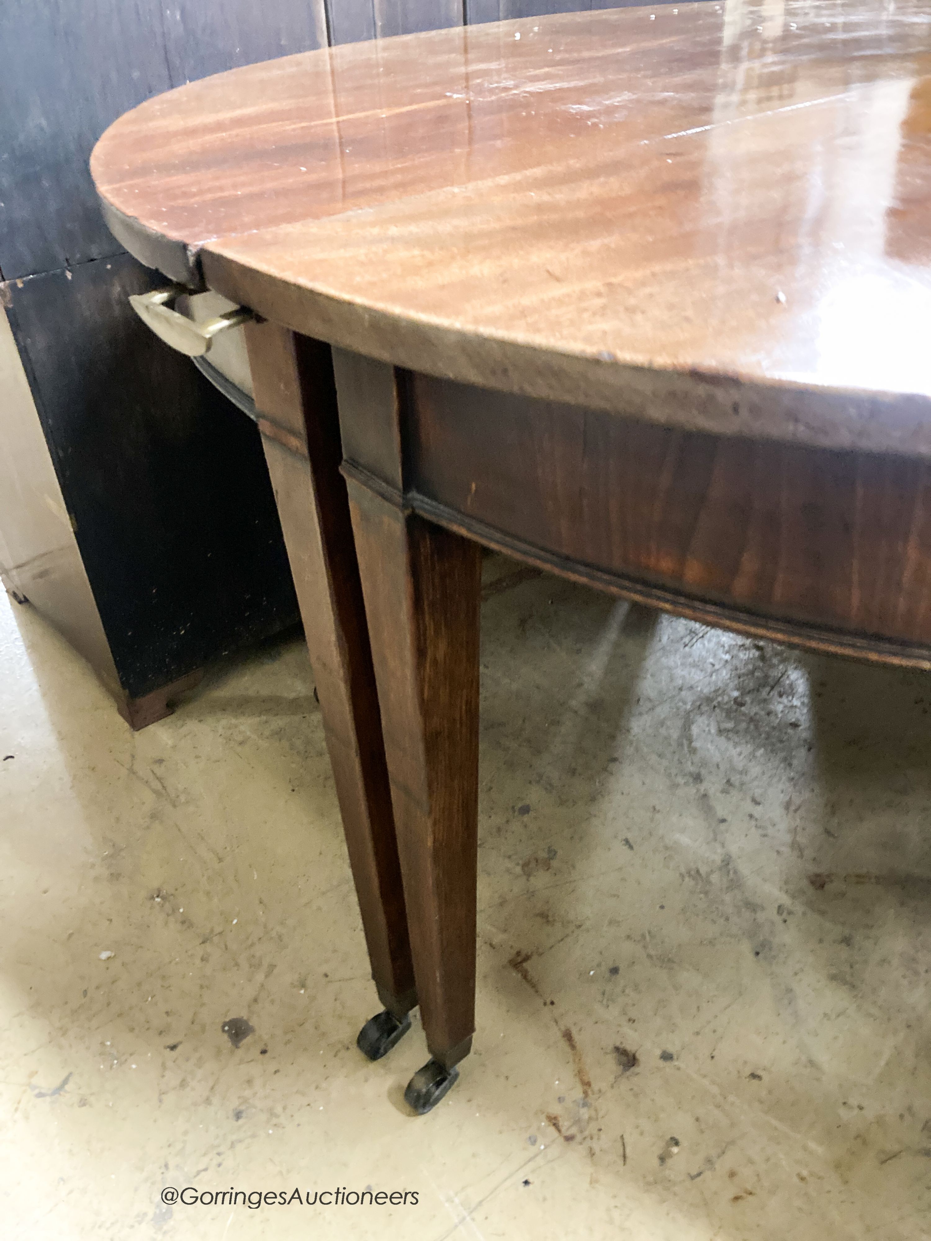 A pair of George III mahogany D shaped table sections, each measures length 120cm, depth 56cm, height 70cm